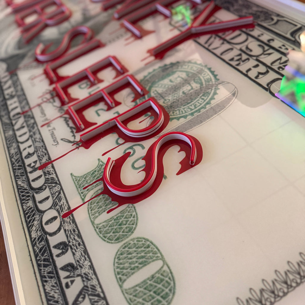 Close-up of a dollar bill with red text overlay