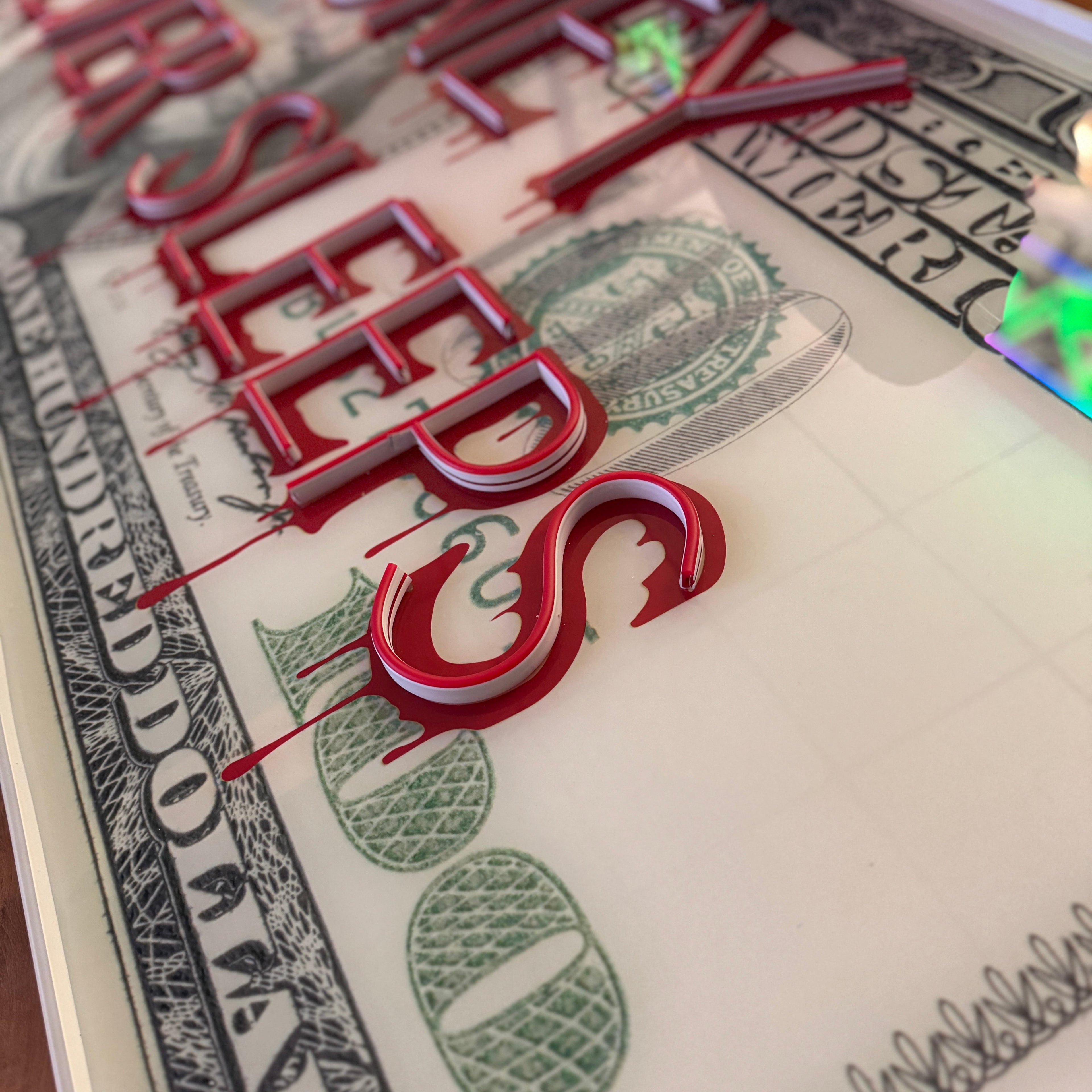 Close-up of a dollar bill with red text overlay